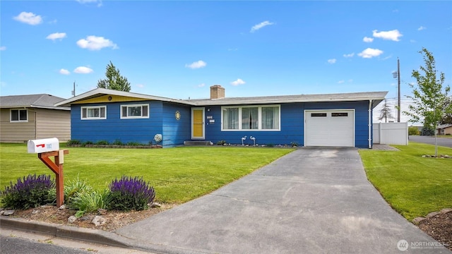 1102 E Elm St, Othello, WA 99344 - ranch-style house featuring an attached garage, a chimney, a front lawn, and asphalt driveway