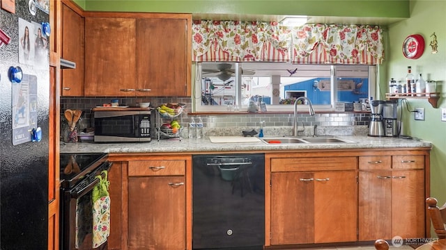 1102 E Elm St, Othello, WA 99344 - kitchen with black appliances, a sink, tasteful backsplash, light countertops, and brown cabinetry