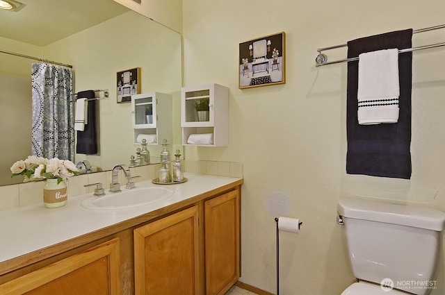 1604 11th Ave S Unit 402, Seattle, WA 98134 - bathroom featuring toilet, vanity, a shower with curtain, and baseboards