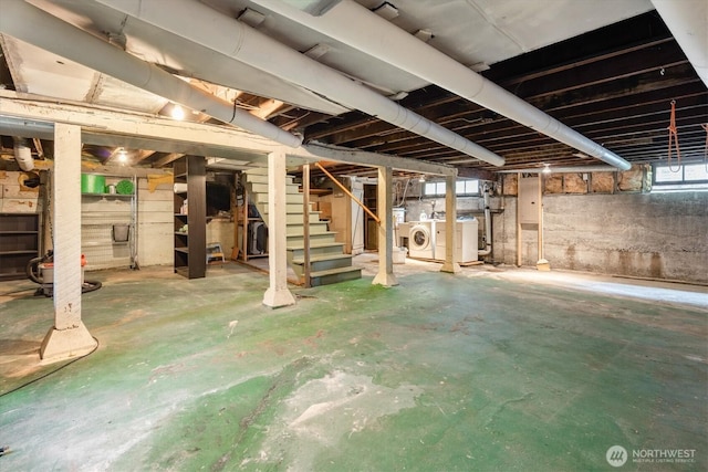 basement featuring stairway and washing machine and dryer