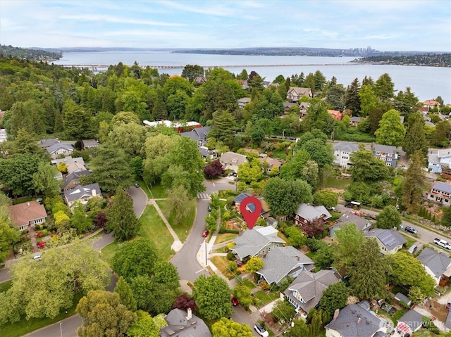 aerial view of residential area featuring a large body of water