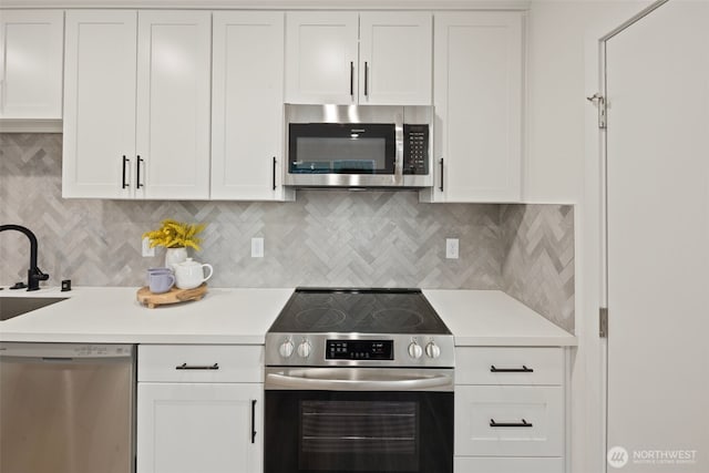 1050C S Donovan St, Seattle, WA 98108 - kitchen featuring stainless steel appliances, white cabinetry, and light countertops