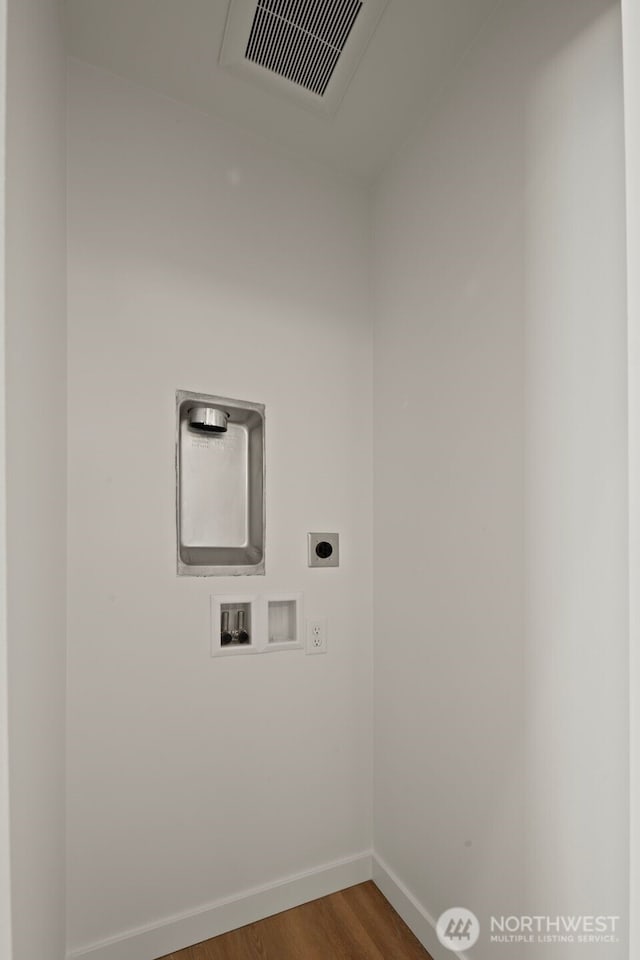 1050C S Donovan St, Seattle, WA 98108 - clothes washing area with hookup for an electric dryer, hookup for a washing machine, baseboards, and wood finished floors