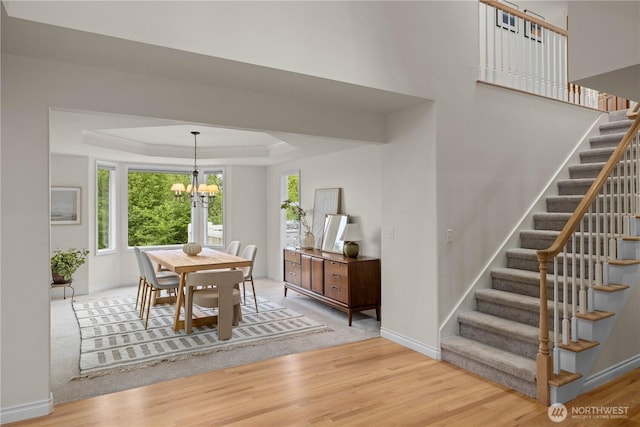 8484 NE County Park Rd, Bainbridge Island, WA 98110 - dining room with a chandelier, stairway, wood finished floors, and baseboards