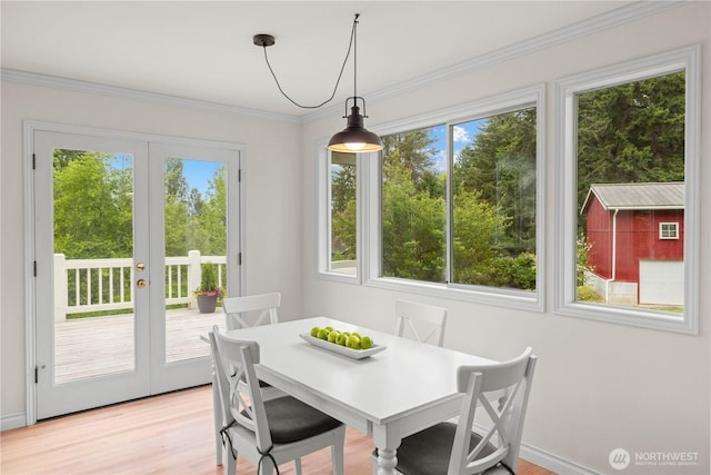 8484 NE County Park Rd, Bainbridge Island, WA 98110 - dining room featuring healthy amount of natural light, french doors, light wood finished floors, and ornamental molding