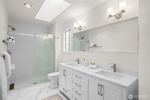 8484 NE County Park Rd, Bainbridge Island, WA 98110 - bathroom featuring a shower stall, a skylight, toilet, double vanity, and marble finish flooring
