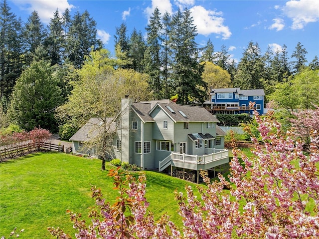 8484 NE County Park Rd, Bainbridge Island, WA 98110 - rear view of house with a chimney, a wooden deck, and view of scattered trees