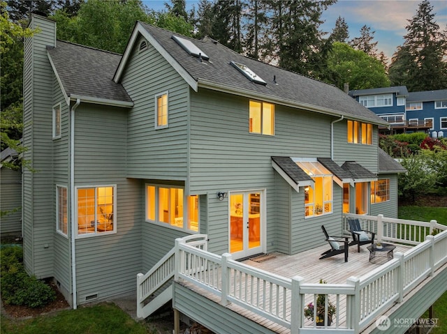 8484 NE County Park Rd, Bainbridge Island, WA 98110 - back of property with a chimney, a wooden deck, and a shingled roof