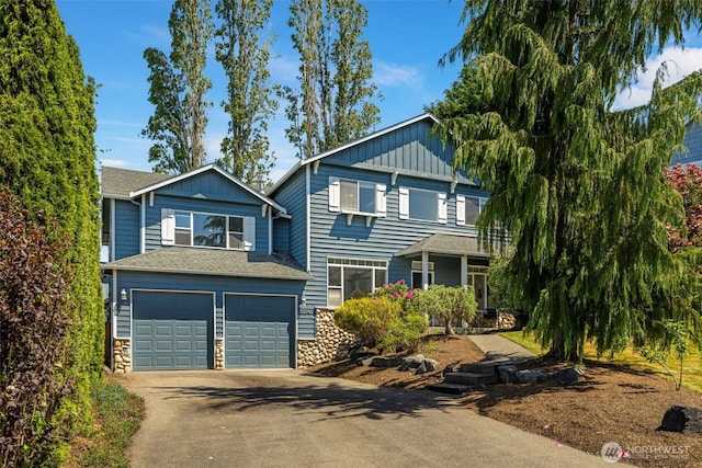 20347 86th Pl NE, Bothell, WA 98011 - view of front of house featuring driveway, a garage, board and batten siding, and stone siding