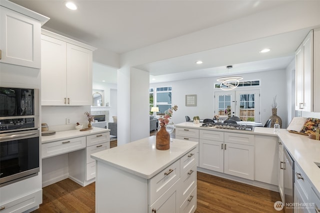 20347 86th Pl NE, Bothell, WA 98011 - kitchen with appliances with stainless steel finishes, dark wood-type flooring, light countertops, white cabinets, and a peninsula
