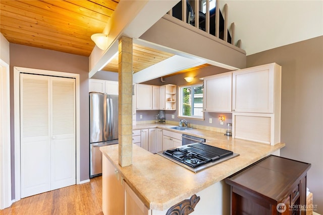 495 Colville Ln, Conner, WA 98257 - kitchen with stainless steel appliances, a peninsula, wood ceiling, white cabinets, and open shelves