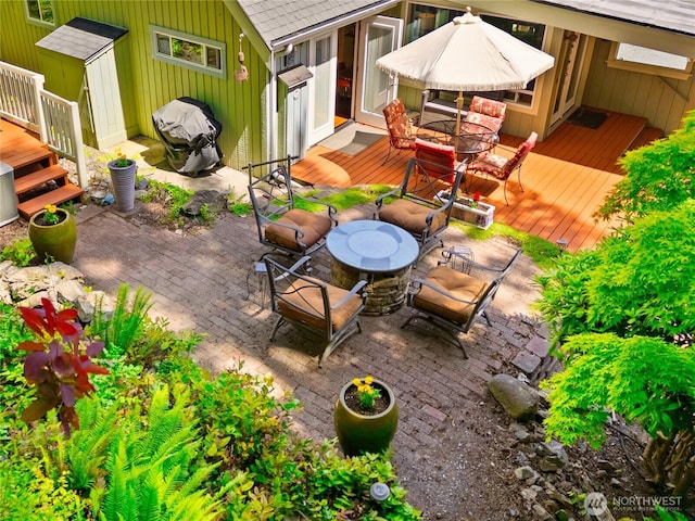 495 Colville Ln, Conner, WA 98257 - view of patio featuring a wooden deck and outdoor dining area