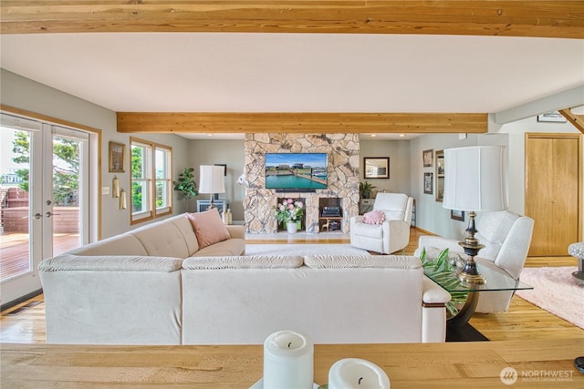 4020 Mayne Ln, Ferndale, WA 98248 - living room featuring wood finished floors, beamed ceiling, french doors, and a stone fireplace