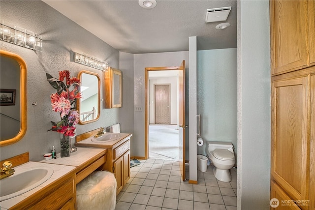 4020 Mayne Ln, Ferndale, WA 98248 - full bathroom featuring tile patterned floors, double vanity, toilet, and a textured wall