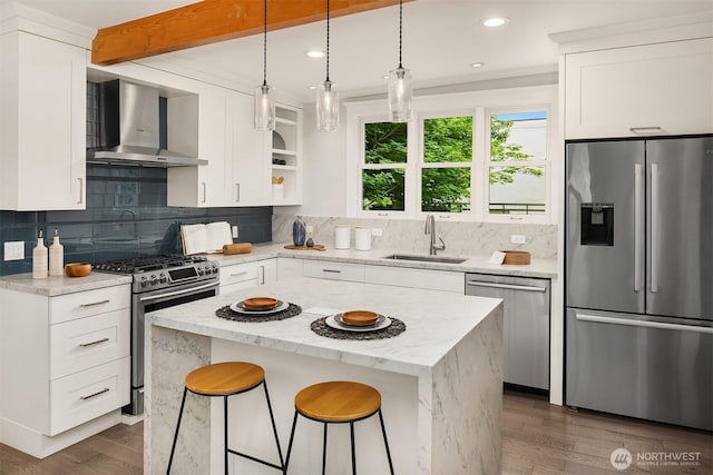 421 16th Ave E, Seattle, WA 98112 - kitchen featuring appliances with stainless steel finishes, wall chimney range hood, a sink, open shelves, and dark wood-type flooring