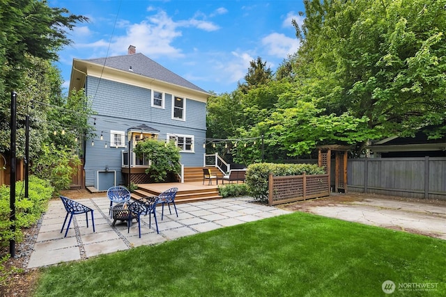 421 16th Ave E, Seattle, WA 98112 - back of property featuring a fire pit, a wooden deck, a chimney, and a patio