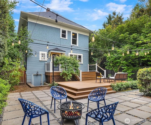 421 16th Ave E, Seattle, WA 98112 - rear view of house with a fire pit, a patio, a wooden deck, and roof with shingles