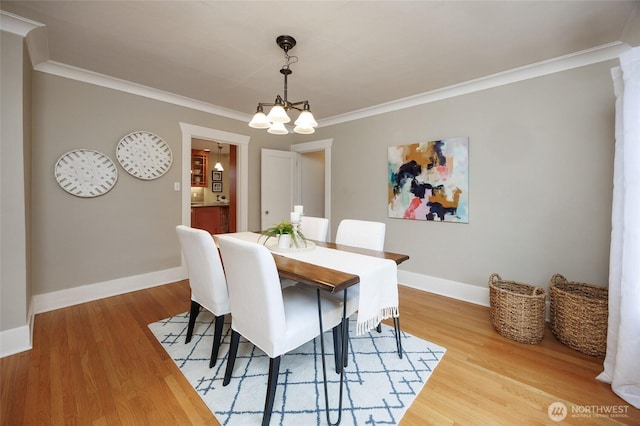 411 NW 56th St, Seattle, WA 98107 - dining room with a chandelier, ornamental molding, wood finished floors, and baseboards