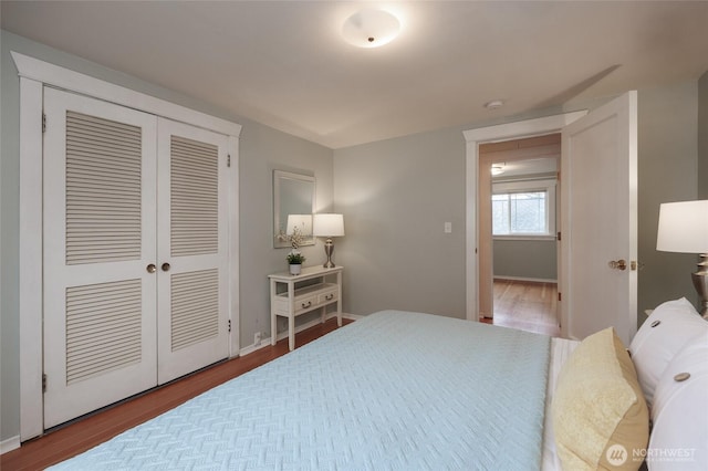 411 NW 56th St, Seattle, WA 98107 - bedroom featuring wood finished floors, a closet, and baseboards