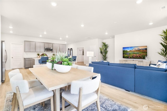 dining space featuring light wood-style floors and recessed lighting