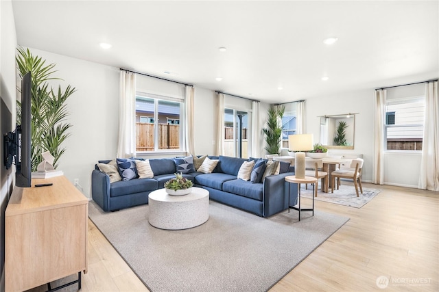 living room featuring light wood-style flooring and recessed lighting