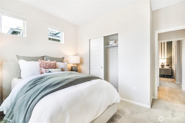 bedroom with baseboards, a closet, and carpet floors
