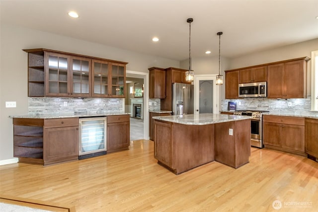 3612 Spyglass Dr NE, Tacoma, WA 98422 - kitchen featuring wine cooler, appliances with stainless steel finishes, open shelves, a center island, and decorative backsplash