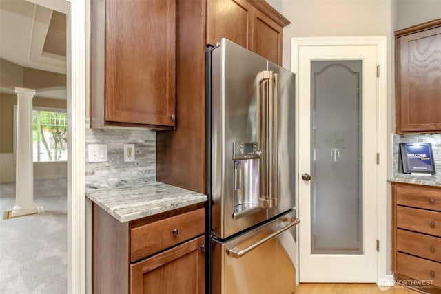 3612 Spyglass Dr NE, Tacoma, WA 98422 - kitchen with high end fridge, ornate columns, decorative backsplash, and brown cabinets
