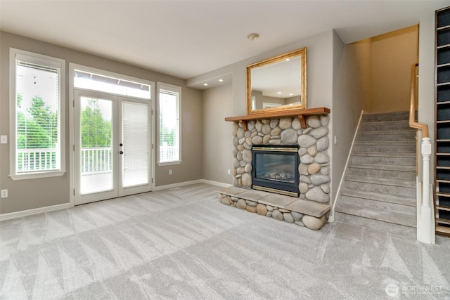 3612 Spyglass Dr NE, Tacoma, WA 98422 - unfurnished living room featuring stairway, baseboards, a stone fireplace, and carpet