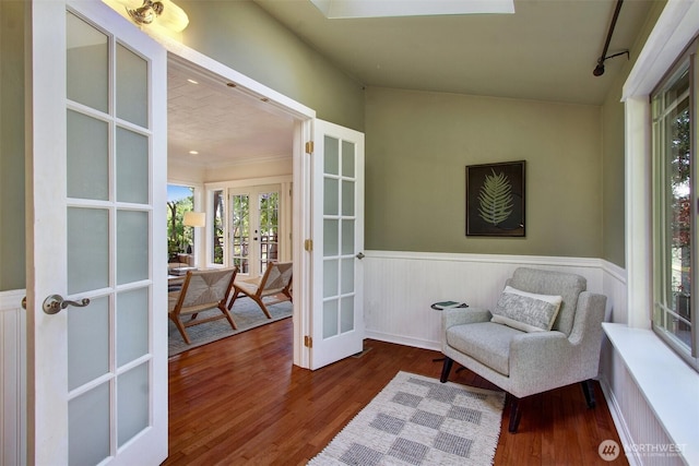 7508 13th Ave SW, Seattle, WA 98106 - living area with french doors, wood finished floors, and wainscoting