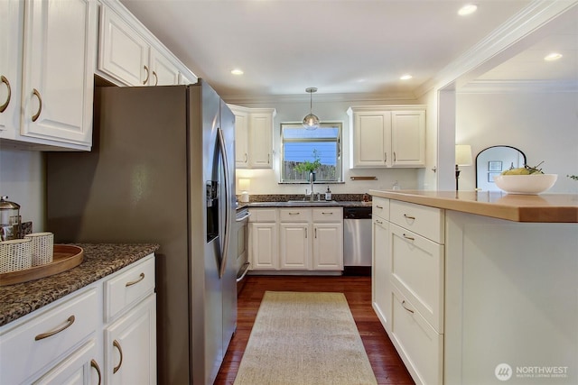 7508 13th Ave SW, Seattle, WA 98106 - kitchen with stainless steel appliances, a sink, white cabinetry, dark wood-type flooring, and crown molding