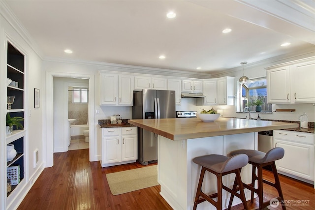 7508 13th Ave SW, Seattle, WA 98106 - kitchen with stainless steel refrigerator with ice dispenser, white cabinetry, under cabinet range hood, a kitchen island, and crown molding