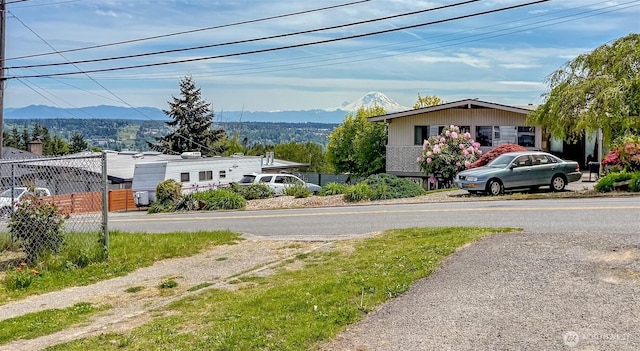 view of asphalt road featuring a mountain view
