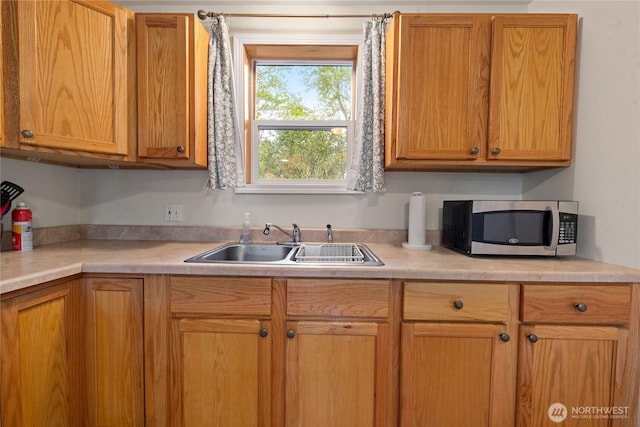 2019 Joe Johns Rd, Ocean Park, WA 98640 - kitchen featuring stainless steel microwave, a sink, and light countertops