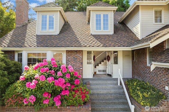 4877 167th Ave SE, Bellevue, WA 98006 - property entrance featuring a chimney, a shingled roof, and brick siding