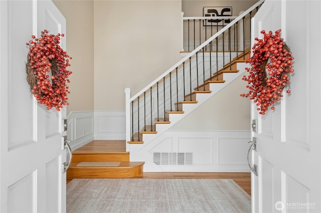 4877 167th Ave SE, Bellevue, WA 98006 - foyer with a decorative wall, wood finished floors, a wainscoted wall, and stairs