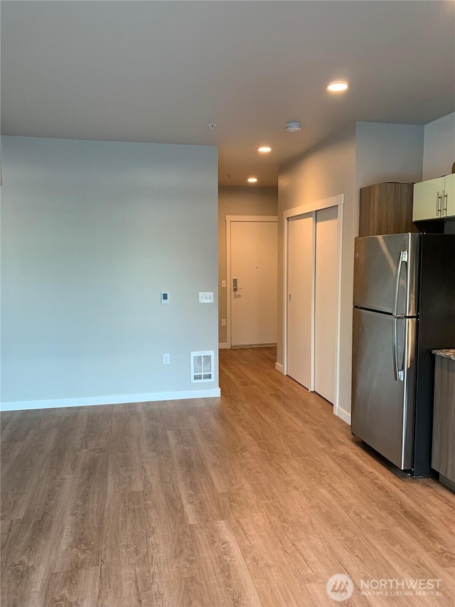 kitchen with freestanding refrigerator, light wood-style flooring, baseboards, recessed lighting, and modern cabinets