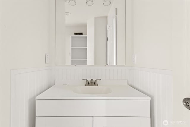 320 Kearney St, Centralia, WA 98531 - bathroom with a wainscoted wall, vanity, and a decorative wall