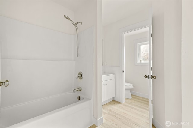 320 Kearney St, Centralia, WA 98531 - bathroom with toilet, washtub / shower combination, baseboards, vanity, and wood finished floors