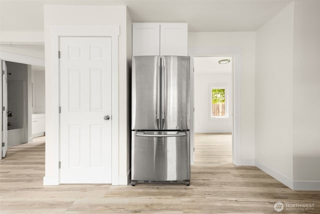 320 Kearney St, Centralia, WA 98531 - kitchen featuring freestanding refrigerator, white cabinets, light wood-style flooring, and baseboards