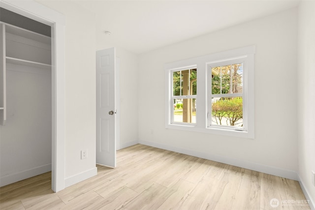 320 Kearney St, Centralia, WA 98531 - unfurnished bedroom with baseboards, light wood-style floors, and a closet