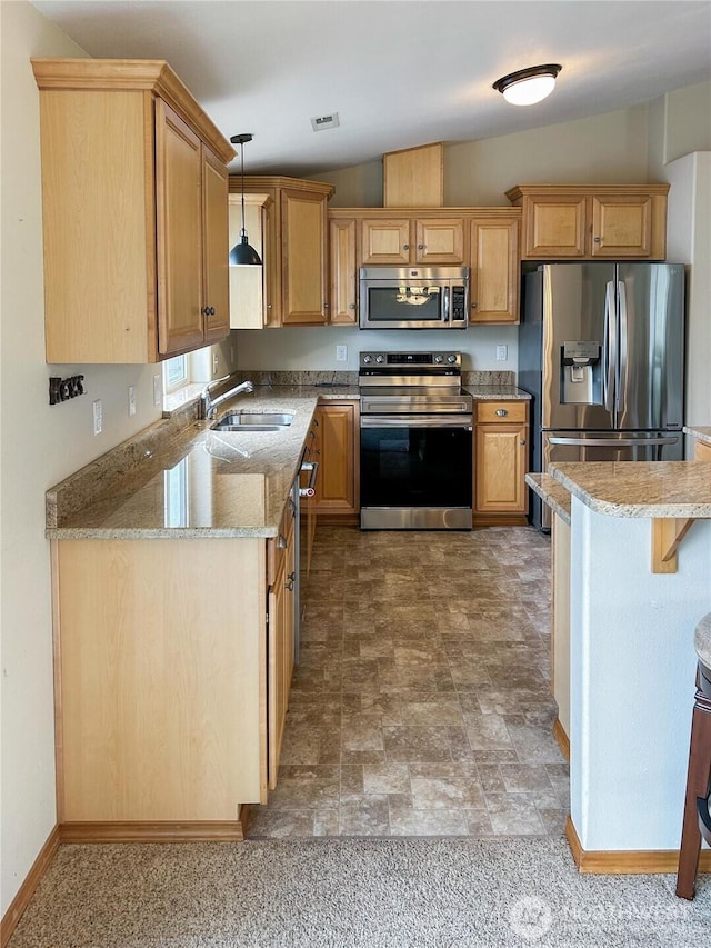 510 Oregon Ave N, Long Beach, WA 98631 - kitchen featuring stainless steel appliances, a sink, pendant lighting, light stone countertops, and lofted ceiling