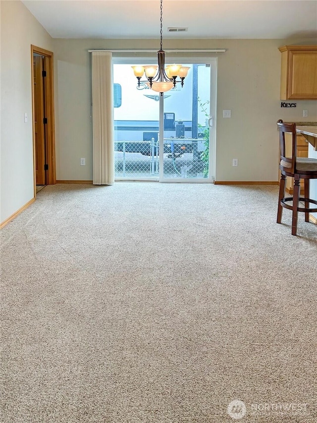 510 Oregon Ave N, Long Beach, WA 98631 - unfurnished dining area featuring a chandelier, baseboards, and carpet floors