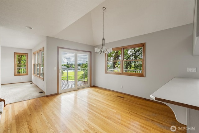 187 Acorn, Longview, WA 98632 - unfurnished dining area featuring a chandelier, light wood-style floors, baseboards, and lofted ceiling