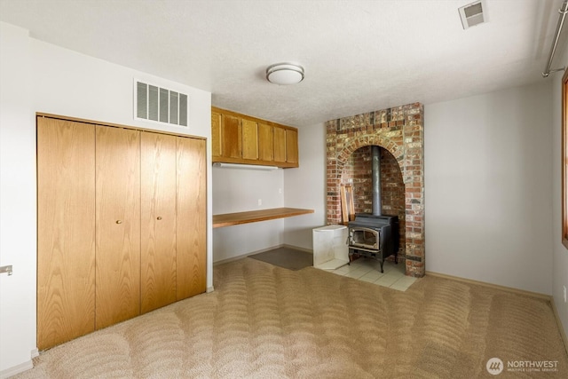 187 Acorn, Longview, WA 98632 - unfurnished office with carpet floors, a wood stove, and baseboards