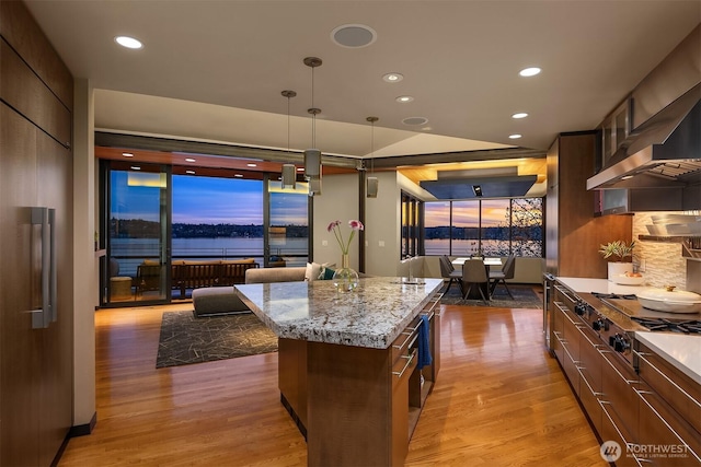 7703 W Mercer Way, Mercer Island, WA 98040 - kitchen with stainless steel gas cooktop, wood finished floors, a kitchen island, modern cabinets, and recessed lighting