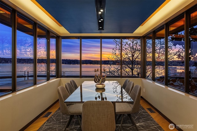 7703 W Mercer Way, Mercer Island, WA 98040 - sunroom / solarium with a water view, wood finished floors, and baseboards