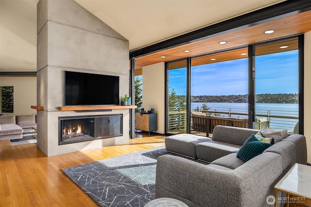 7703 W Mercer Way, Mercer Island, WA 98040 - living room with wood finished floors, a fireplace, expansive windows, and recessed lighting