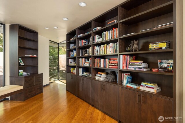 7703 W Mercer Way, Mercer Island, WA 98040 - office area featuring light wood-type flooring, floor to ceiling windows, recessed lighting, and wall of books