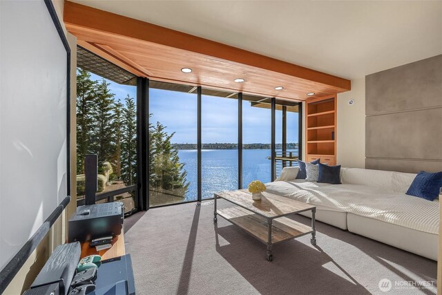 7703 W Mercer Way, Mercer Island, WA 98040 - living room with a water view, plenty of natural light, floor to ceiling windows, carpet flooring, and recessed lighting